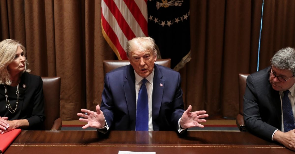 President Donald Trump speaks as Attorney General William Barr listens during a discussion with state attorneys general in the Cabinet Room of the White House on Sept. 23, 2020, in Washington, D.C.