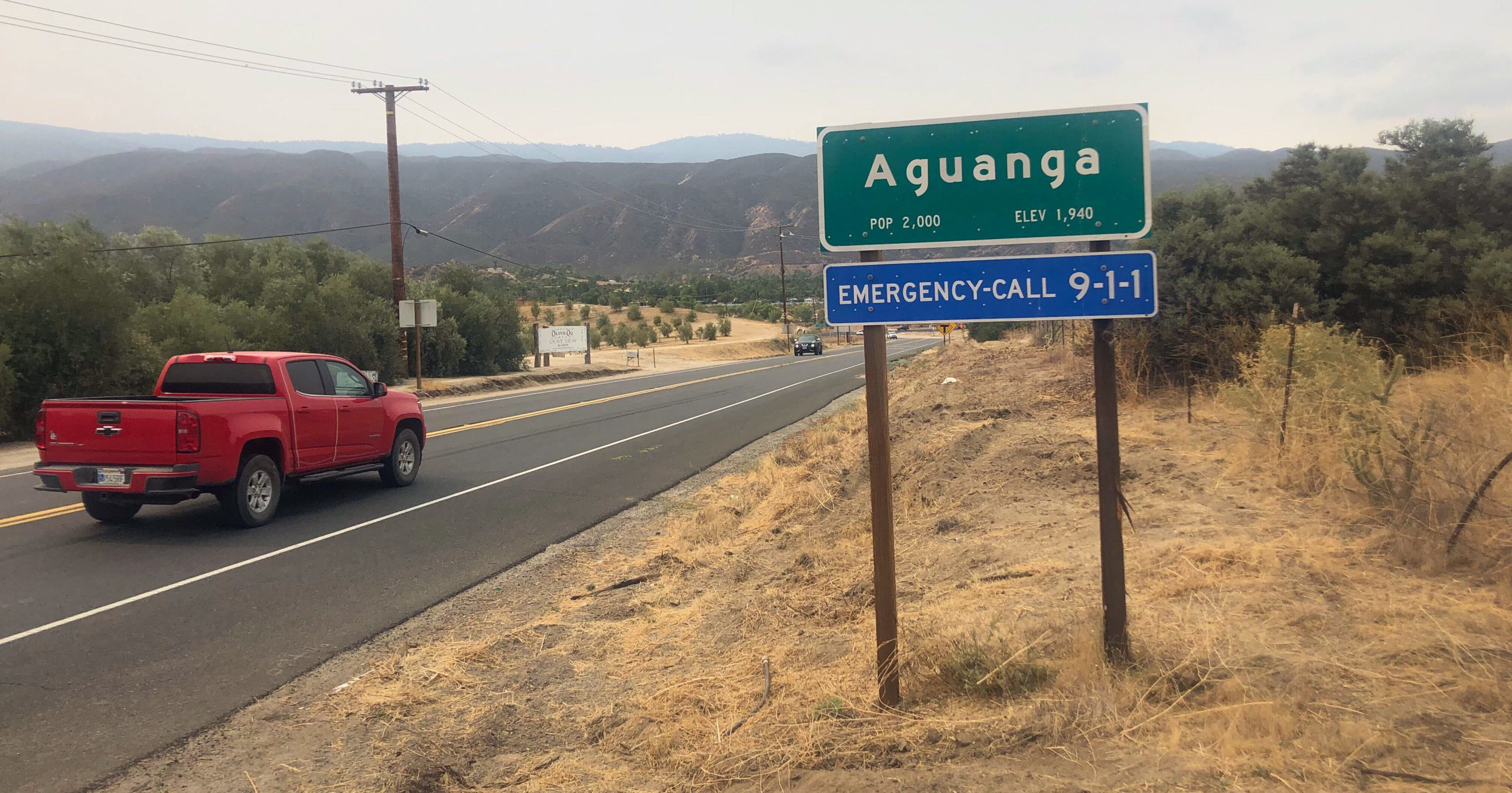 Traffic passes along State Route 371 entering the town of Aguanga, California, on Sep. 8, 2020.