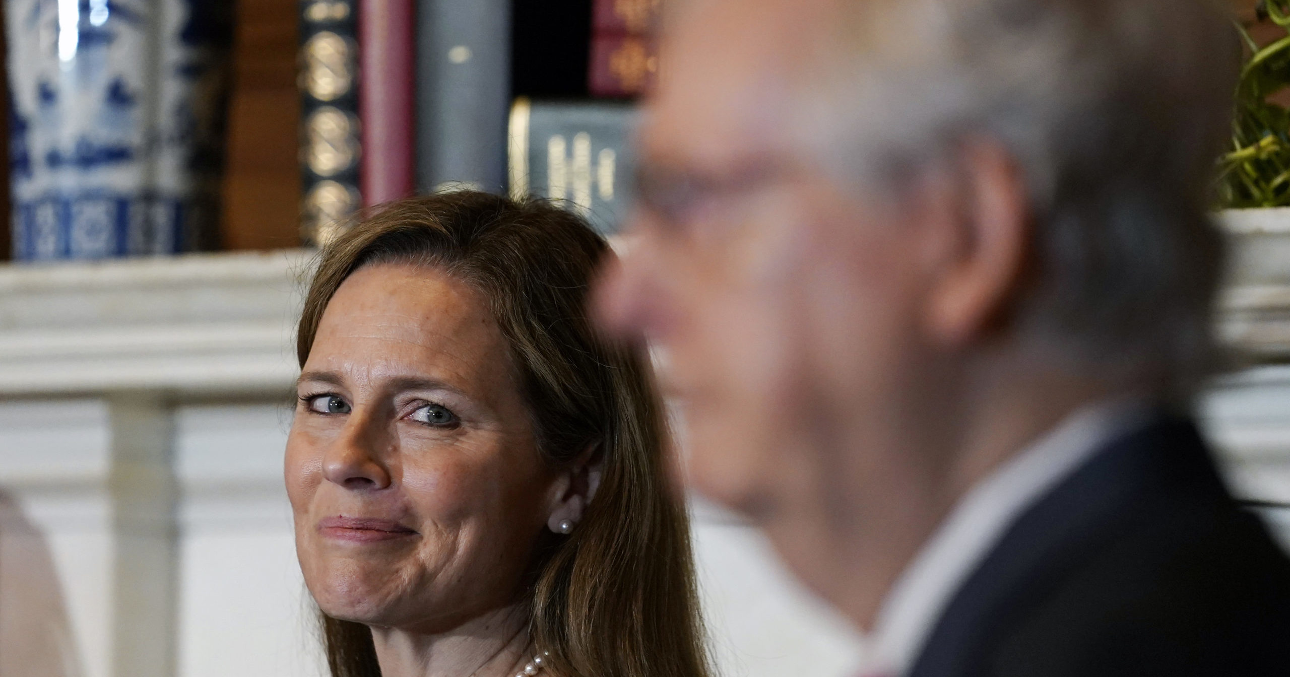 Supreme Court nominee Judge Amy Coney Barrett looks over to Senate Majority Leader Mitch McConnell of Kentucky as they meet on Capitol Hill in Washington on Sept. 29, 2020.