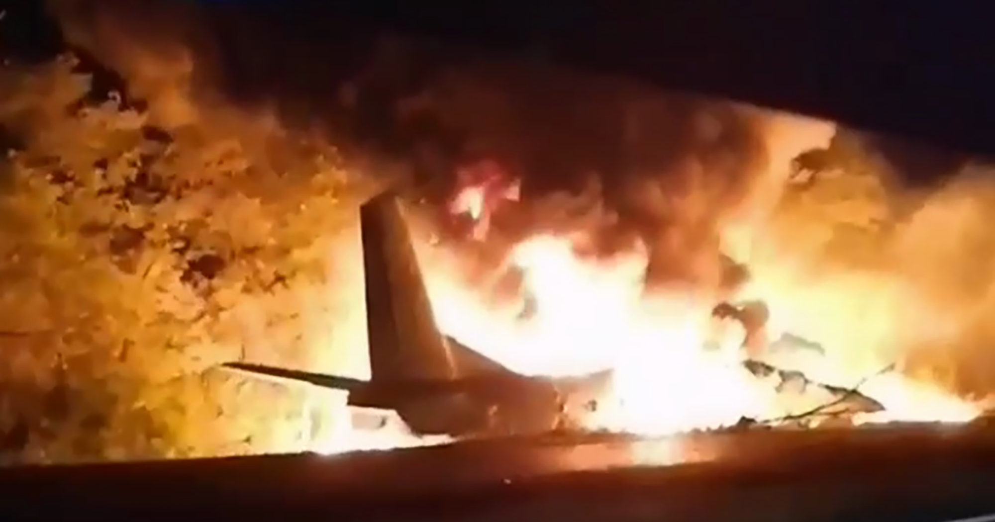 In this image from footage released by Ukraine's Emergency Situation Ministry, an AN-26 military plane bursts into flames after crashing in the town of Chuguyiv, Ukraine, on Sept. 25, 2020. Twenty-six people were killed.