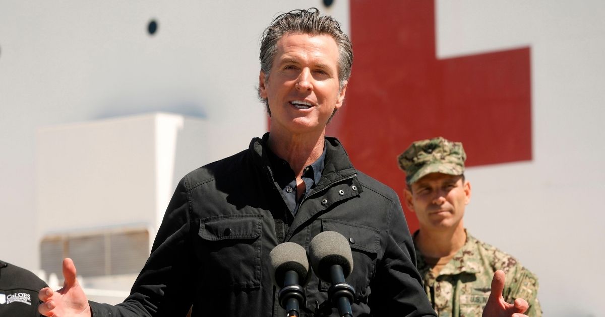 California Gov. Gavin Newsom speaks in front of the hospital ship USNS Mercy at the Port of Los Angeles on March 27, 2020.