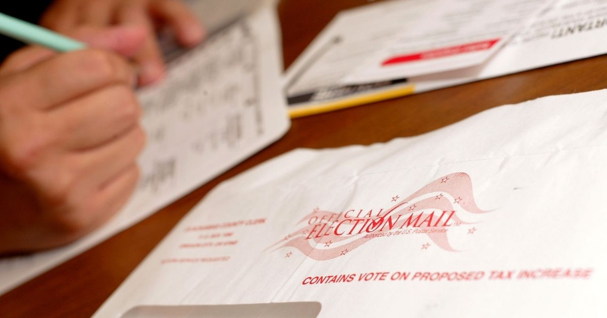 Jaime Valdez casts a ballot from his home on Nov. 1, 2004, in Wilsonville, Oregon.