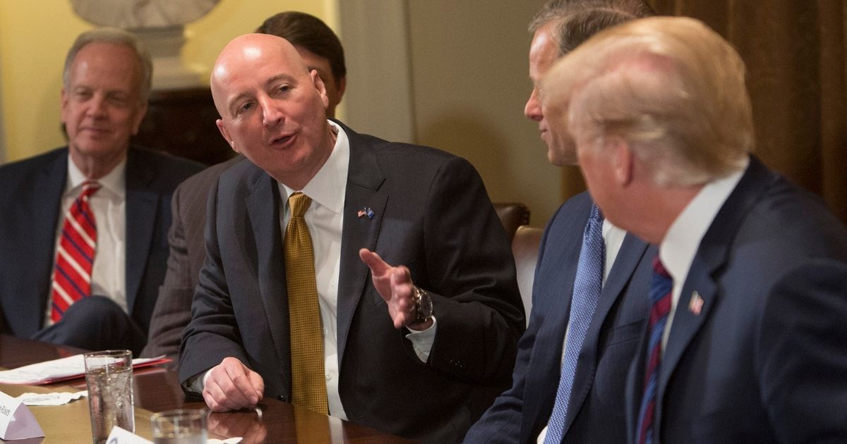 Nebraska Governor Pete Ricketts speaks to President Donald Trump during a meeting on trade with governors and members of Congress at the White House on April 12, 2018, in Washington, D.C.
