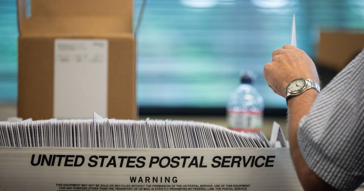 Election workers stuff ballot applications at the Mecklenburg County Board of Elections office in Charlotte, North Carolina, on Sep. 4, 2020.