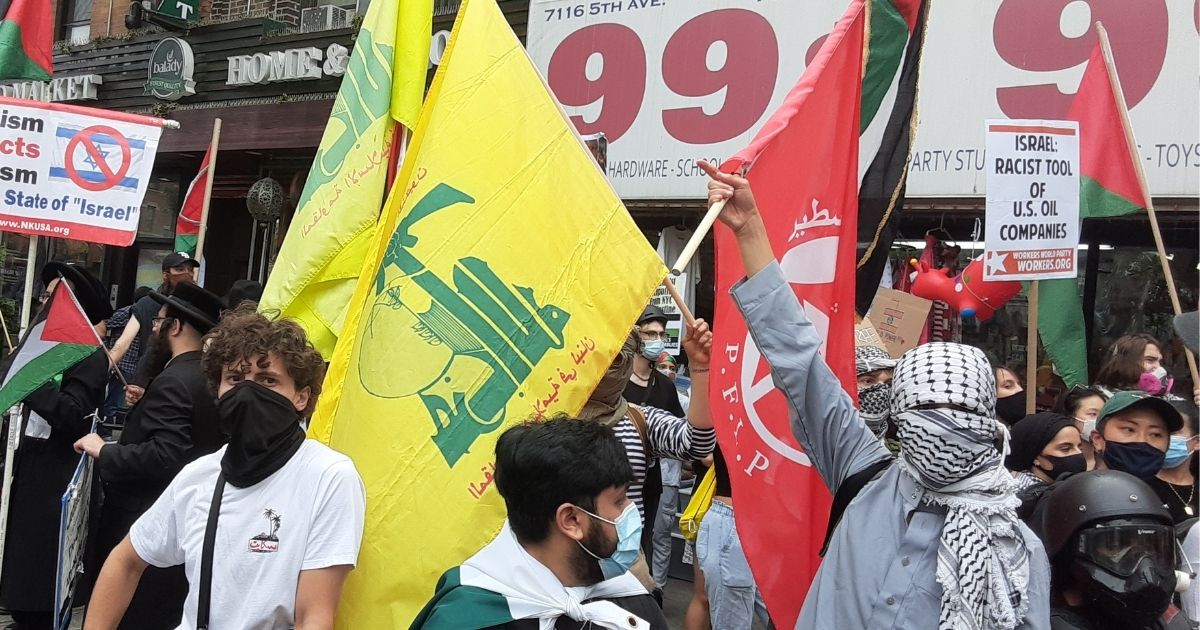 Pro-Palestine demonstrators carry the flags of terrorist organizations during a protest in New York on Aug. 7, 2020.