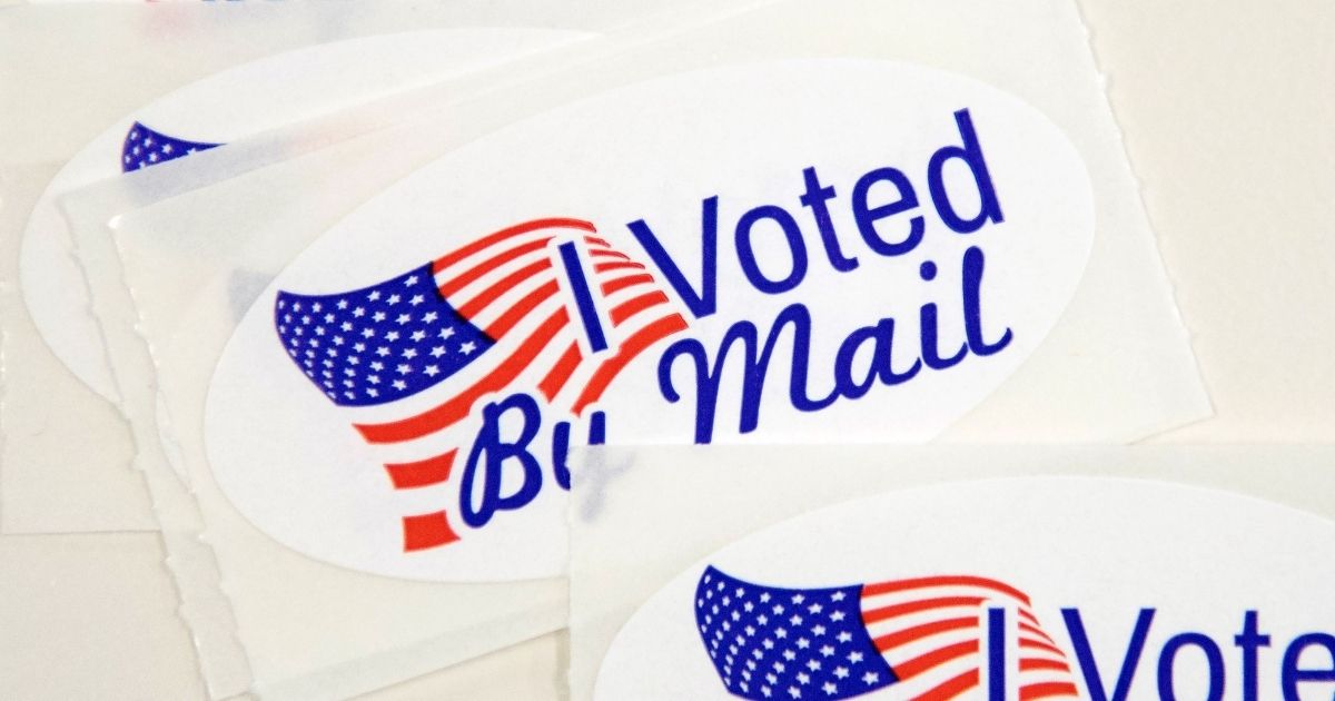 Stickers that read "I Voted By Mail" sit on a table waiting to be stuffed into envelopes by election workers at the Mecklenburg County Board of Elections office in Charlotte, North Carolina, on Sept. 4, 2020.