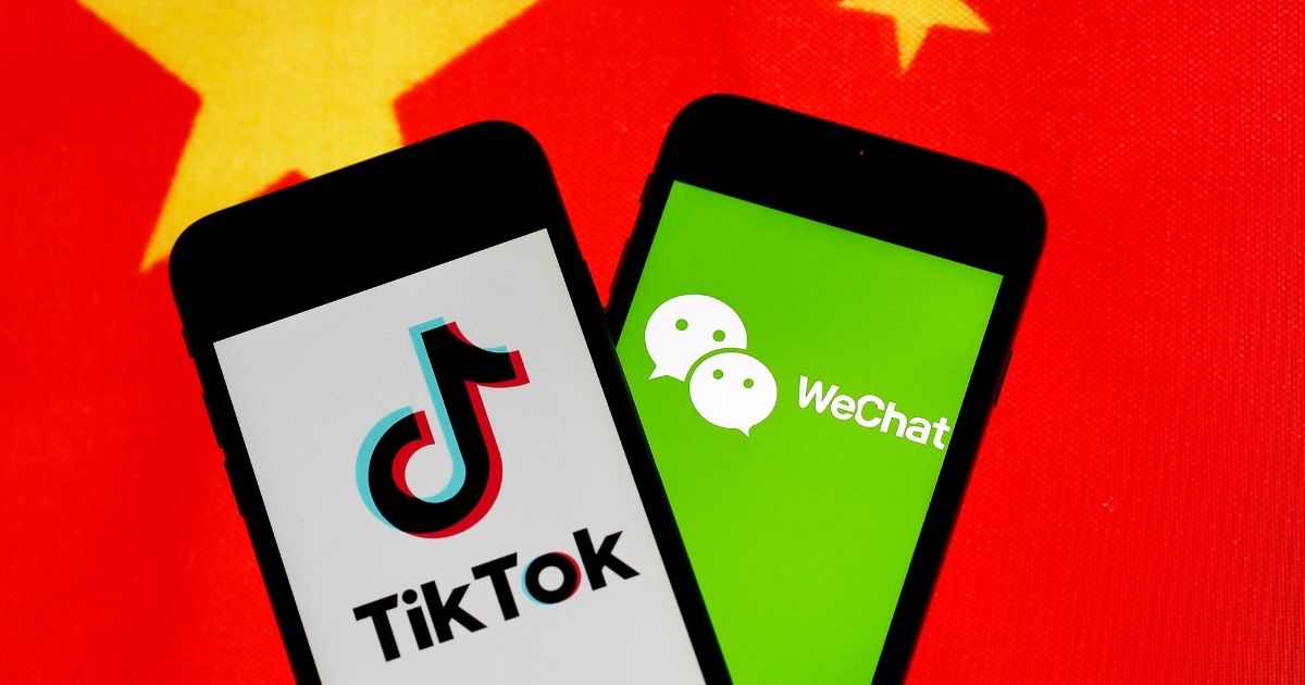 The logos of Chinese apps TikTok and WeChat are displayed on smartphones in front of a Chinese flag on Sept. 18, 2020, in Paris.