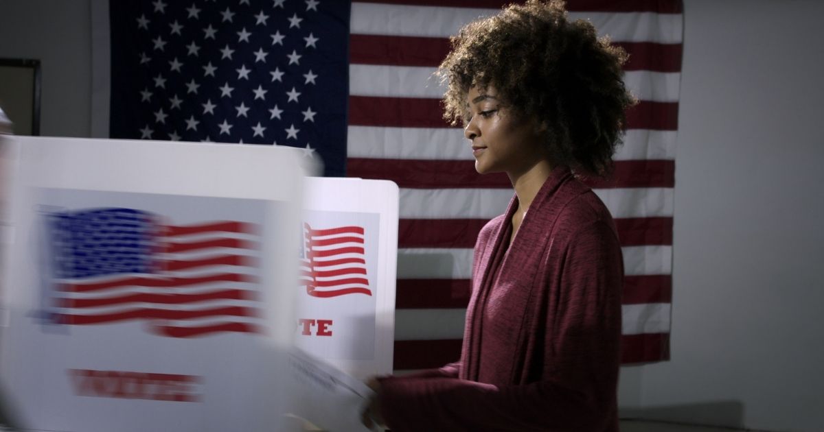 A young woman prepares to vote in the stock image above.