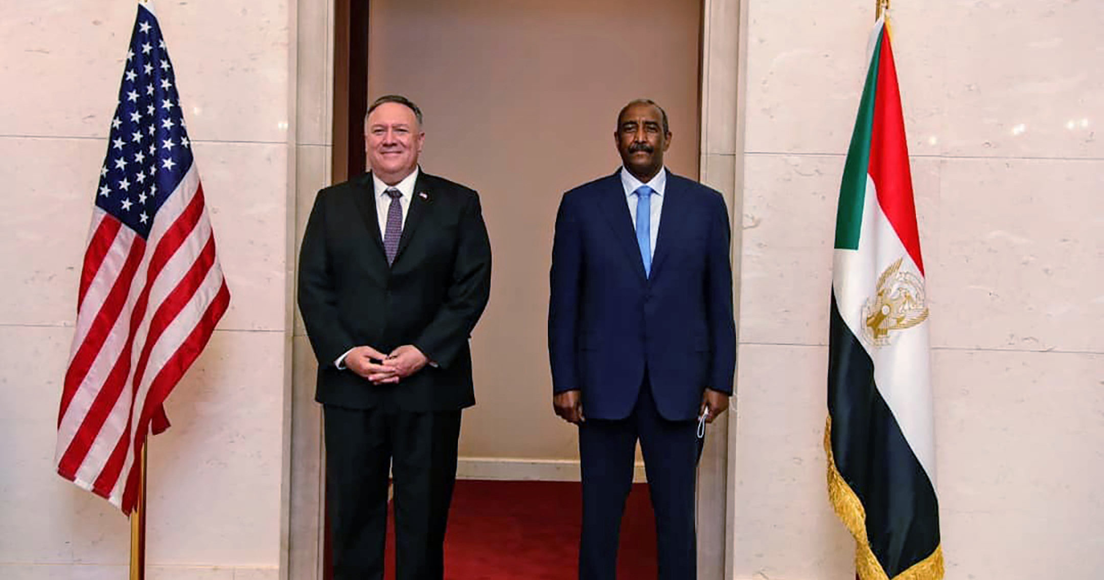 In this Aug. 25, 2020 file photo, US Secretary of State Mike Pompeo stands with Sudanese Gen. Abdel-Fattah Burhan in Khartoum, Sudan.