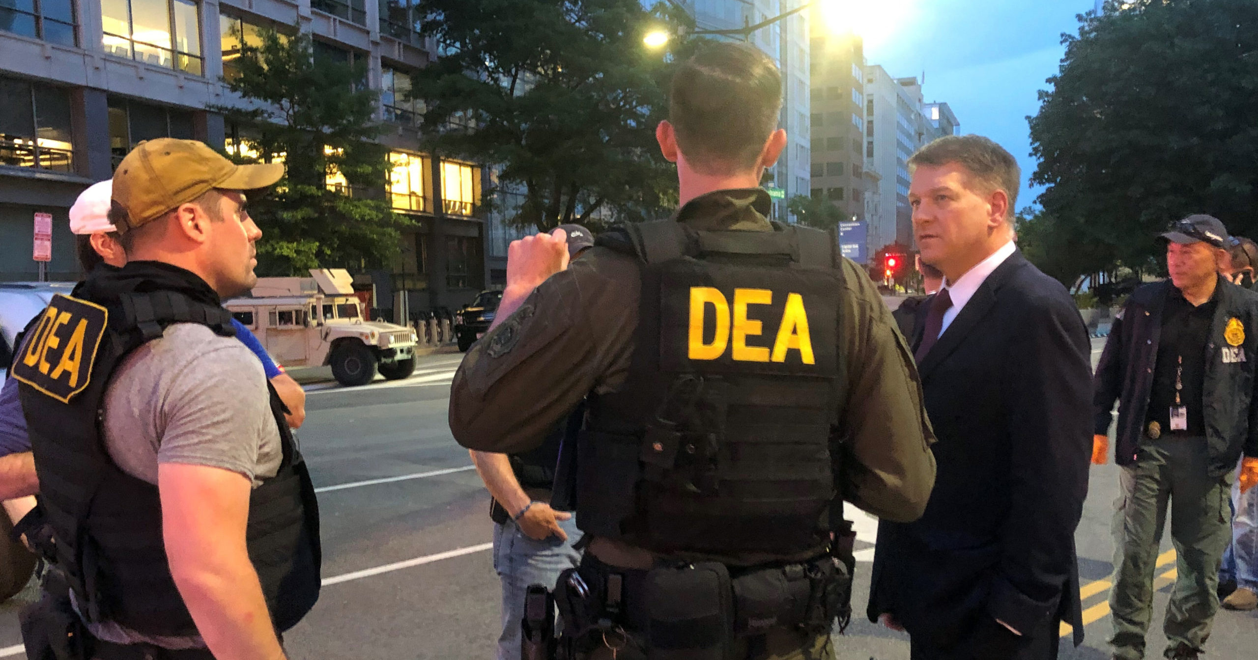 In this June 3, 2020, photo, acting head of the Drug Enforcement Administration Timothy Shea, right, visits with DEA agents at a checkpoint in Washington.