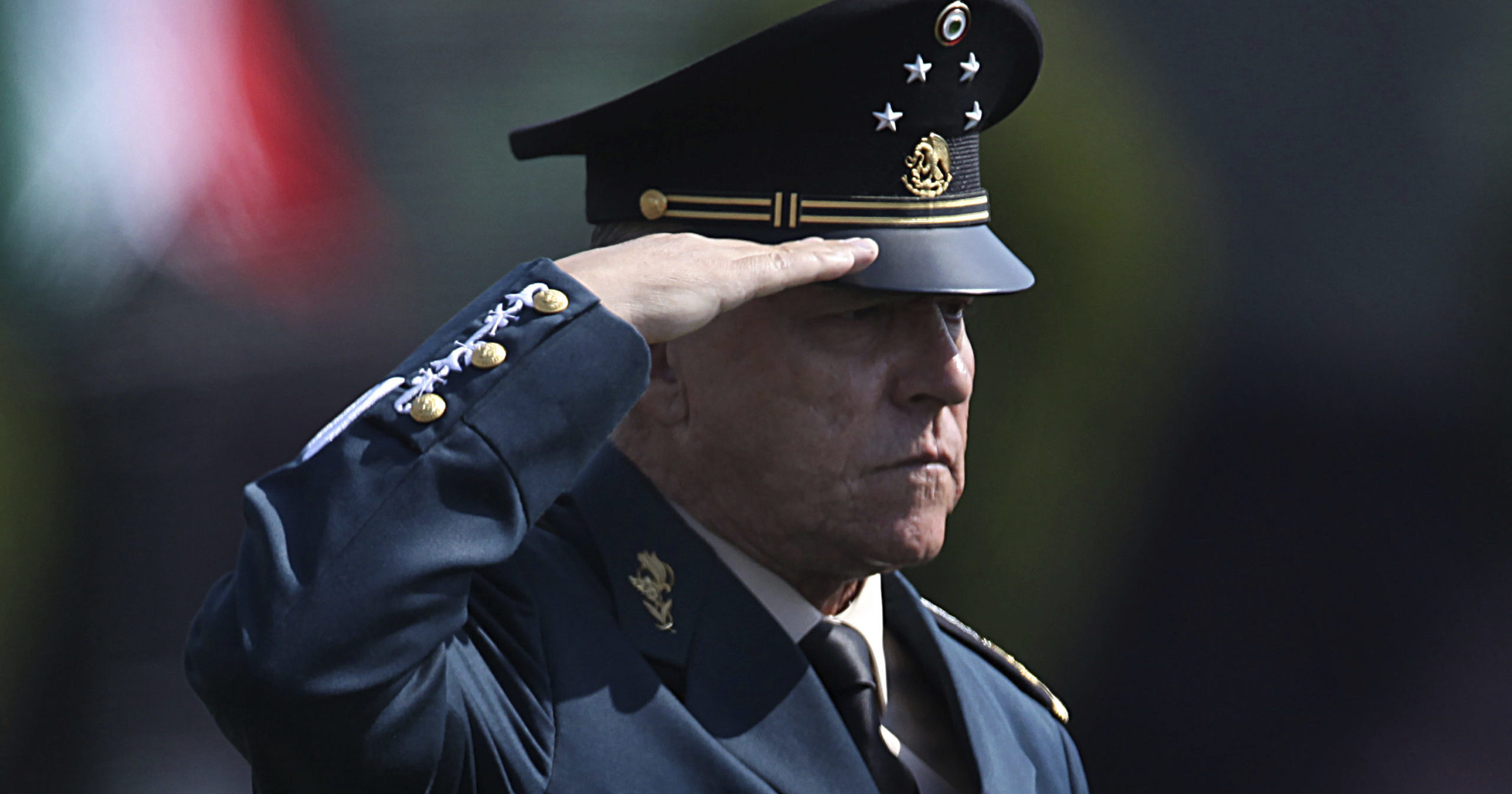 In this April 16, 2016, file photo, Mexico's Defense Secretary Gen. Salvador Cienfuegos Zepeda salutes soldiers at a military camp in Mexico City.