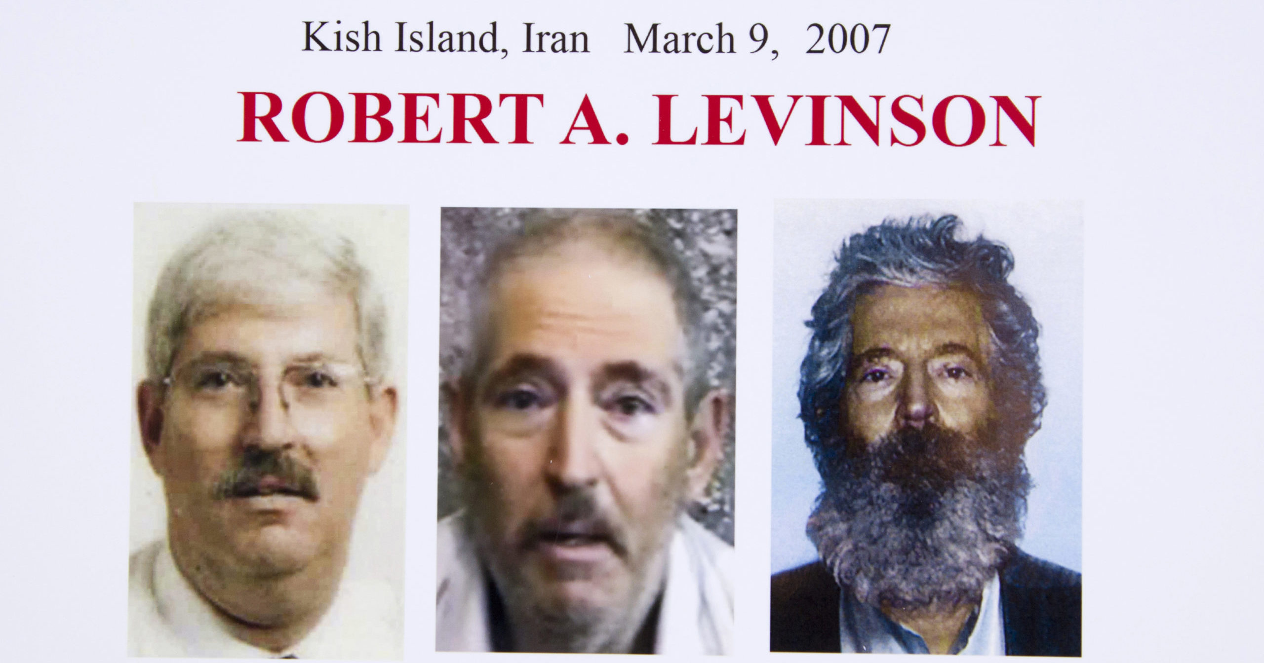 In this March 6, 2012, file photo, an FBI poster displays composite images of former FBI agent Robert Levinson. A US judge ordered Iran on Oct. 1, 2020, to pay $1.45 billion to the family of Levinson, who is believed to have been kidnapped by the Islamic Republic while on an unauthorized CIA mission to an Iranian island in 2007.