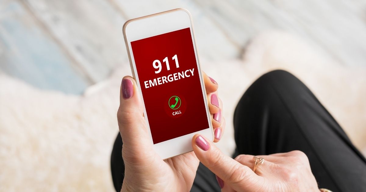 The stock photo above shows a person dialing the emergency number 911 on a phone.