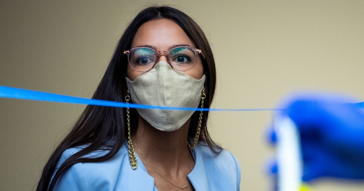 New York Democratic Rep. Alexandria Ocasio-Cortez arrives for a House Oversight and Reform Committee hearing on the Postal Service on Capitol Hill on Aug. 24, 2020, in Washington.