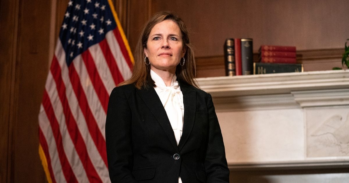 Judge Amy Coney Barrett, President Donald Trump's nominee for the Supreme Court, poses for a photo before a meeting with Montana Republican Sen. Steve Daines at the United States Capitol Building on Oct. 1, 2020, in Washington, D.C.