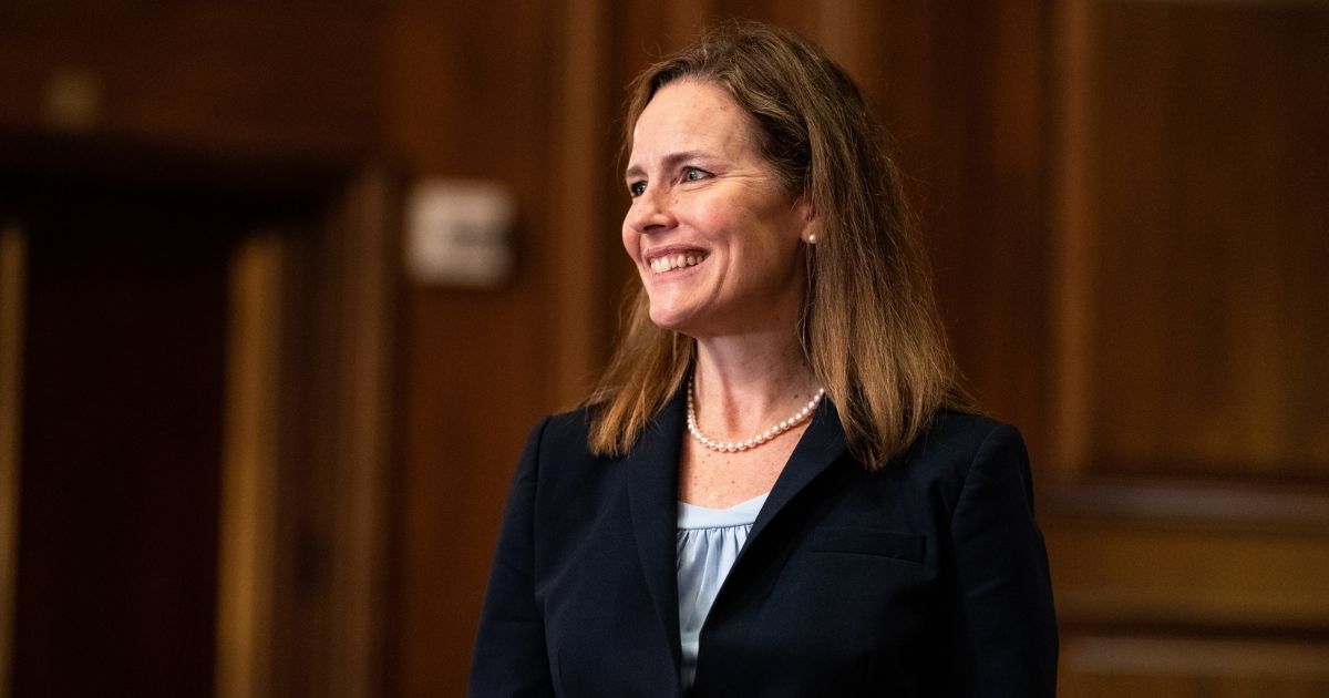 Judge Amy Coney Barrett of the 7th U.S. Circuit Court of Appeals, President Donald Trump's nominee for the Supreme Court, meets with Republican Sen. David Perdue of Georgia at the Capitol on Sept. 30, 2020, in Washington, D.C.