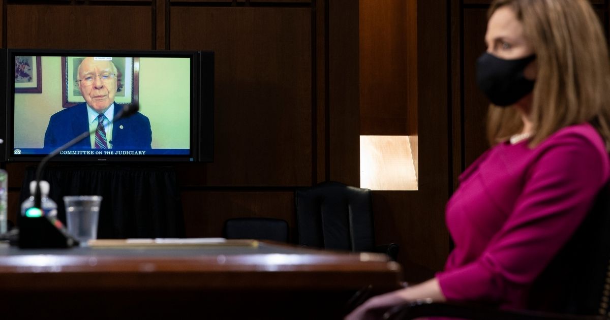 Democratic Sen. Patrick Leahy of Vermont gives his opening statement by video as Judge Amy Coney Barrett looks on during the first day of her Supreme Court confirmation hearing Monday in Washington, D.C.
