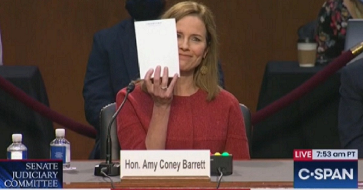 Supreme Court nominee Amy Coney Barrett holds up a blank notepad Tuesday during Day 2 of her confirmation hearing.