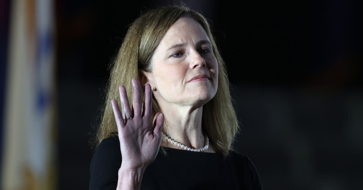 Supreme Court Justice Amy Coney Barrett is sworn in by Justice Clarence Thomas during a ceremony on the South Lawn of the White House on Monday.
