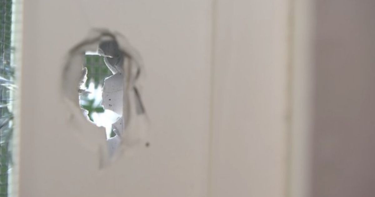 A bullet hole is seen at the Seattle couple's home.