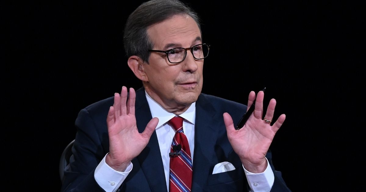 Debate moderator and Fox News anchor Chris Wallace directs the first presidential debate between President Donald Trump and Democratic presidential nominee Joe Biden at the Health Education Campus of Case Western Reserve University on Sept. 29, 2020, in Cleveland, Ohio.