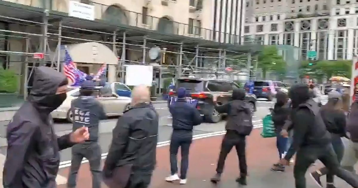 Counterprotesters throw objects at cars in a "Jews for Trump" parade through New York City.