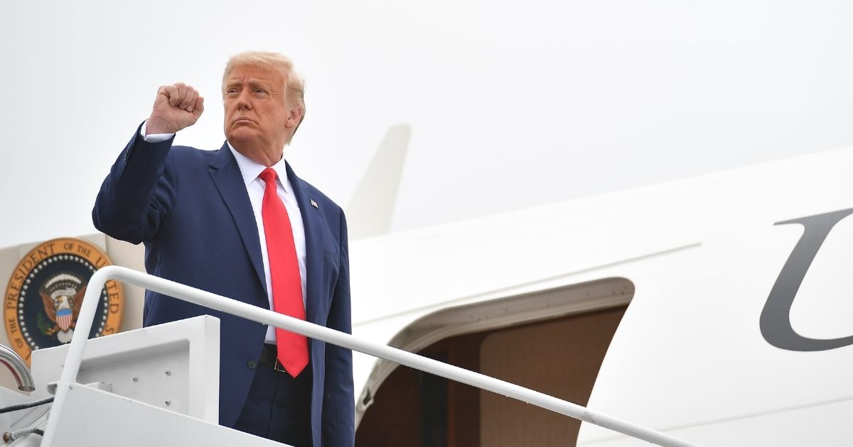 President Donald Trump raises his fist as he makes his way to board Air Force One before departing from Andrews Air Force Base in Maryland on Sept. 1, 2020.