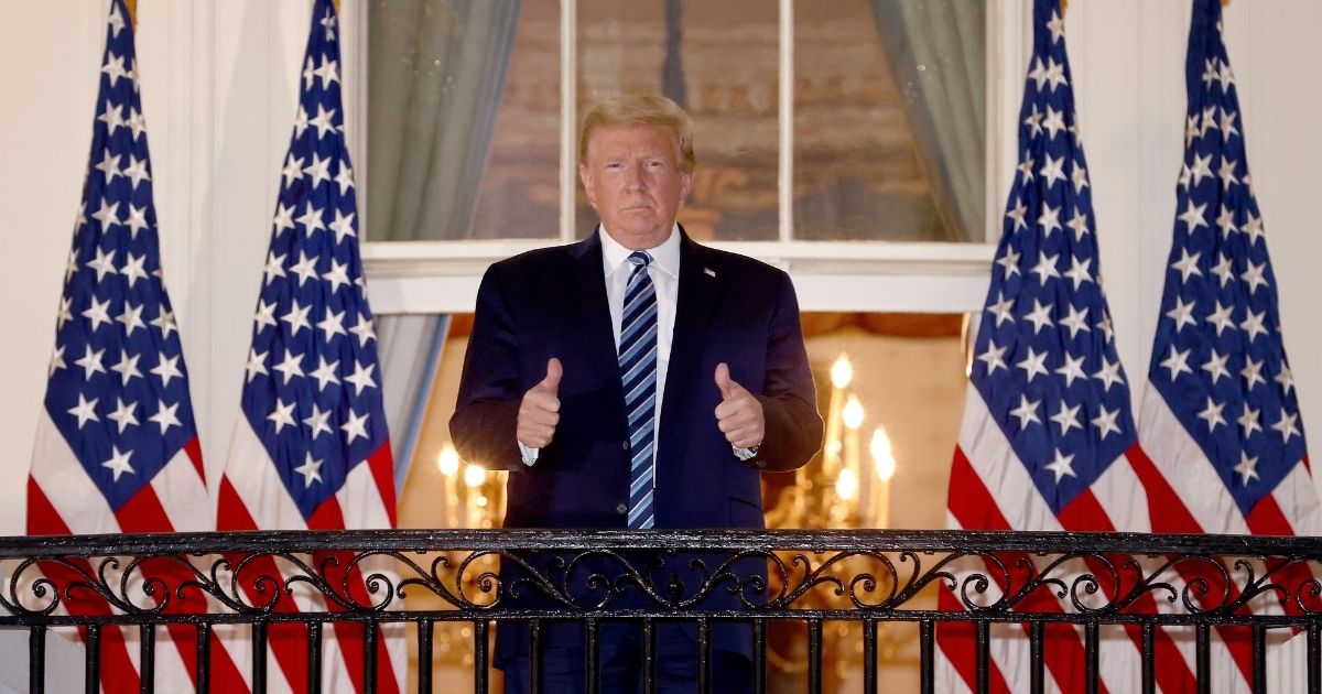 President Donald Trump gives a thumbs up upon returning to the White House from Walter Reed National Military Medical Center on Monday in Washington, D.C.