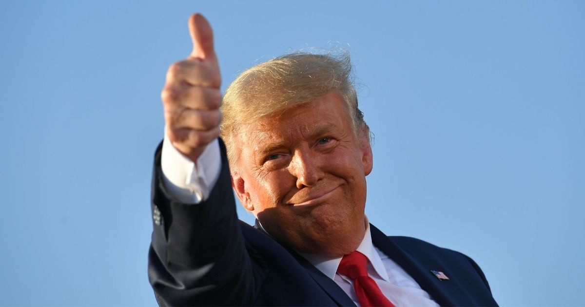 President Donald Trump gives a thumbs up as he leaves a rally at the Tucson International Airport in Arizona on Oct. 19.