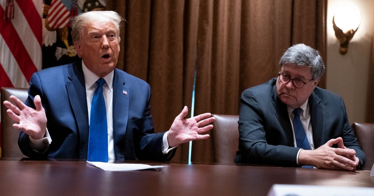 Attorney General William Barr, right, listens as President Donald Trump speaks during a meeting with Republican state attorneys general about social media companies in the Cabinet Room of the White House on Sept. 23, 2020, in Washington