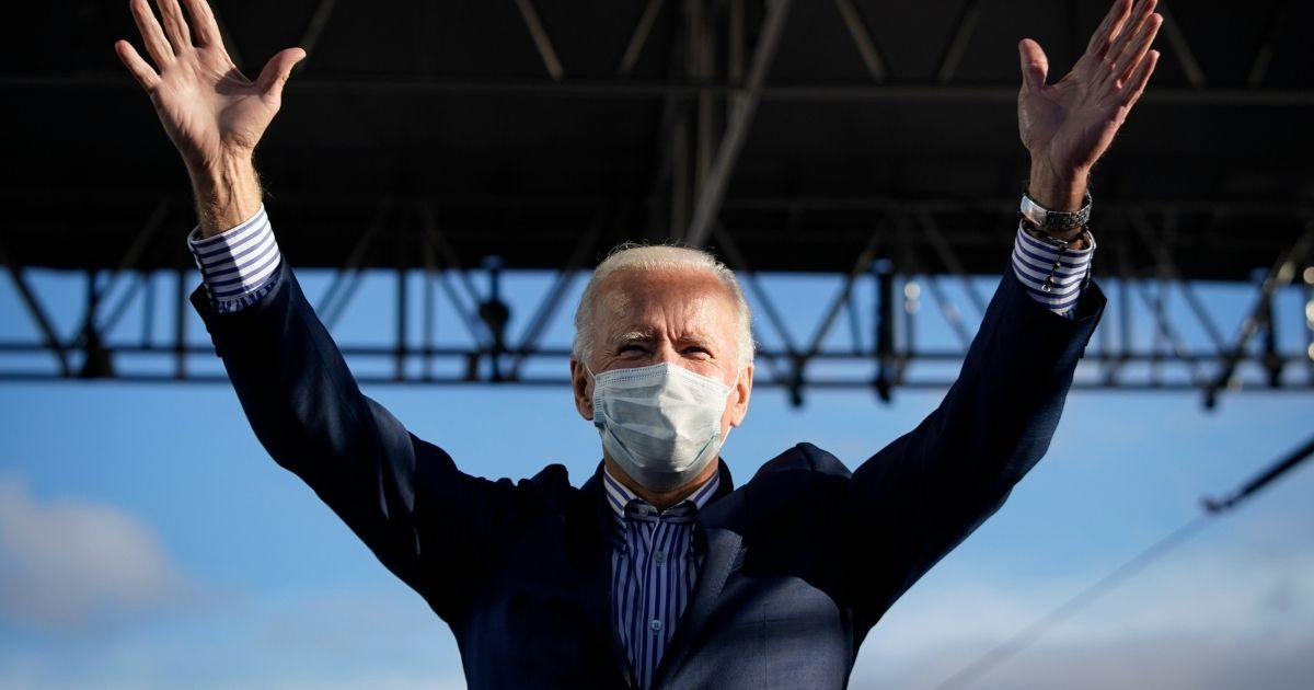 Democratic presidential nominee Joe Biden gestures as he arrives onstage for a drive-in campaign rally at Dallas High School on Friday.