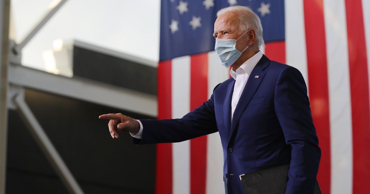 Democratic presidential nominee Joe Biden points to supporters during a drive-in voter mobilization event at Miramar Regional Park on Tuesday in Miramar, Florida.
