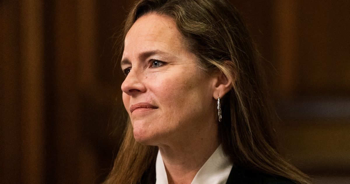 Supreme Court nominee Judge Amy Coney Barrett listens during a meeting with Republican Sen. Steve Daines of Montana on Capitol Hill in Washington on Oct. 1, 2020.