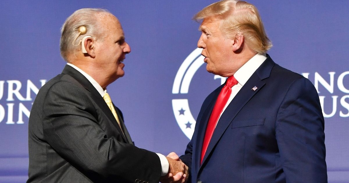 Rush Limbaugh shakes hands with President Donald Trump during the Turning Point USA Student Action Summit at the Palm Beach County Convention Center in West Palm Beach, Florida, on Dec. 21, 2019.