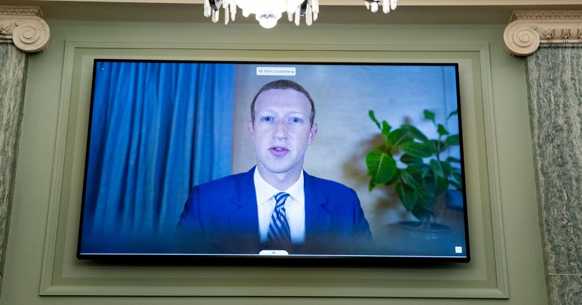 Facebook CEO Mark Zuckerberg appears on a screen as he speaks remotely during a hearing before the Senate Commerce Committee on Capitol Hill on Wednesday in Washington.