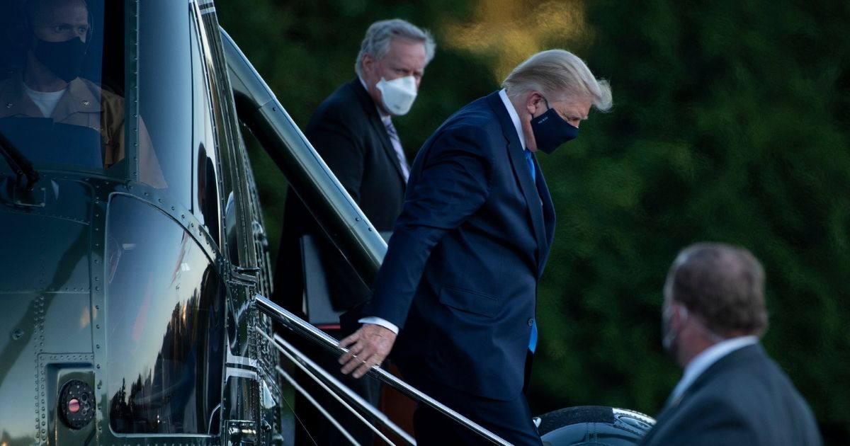 White House Chief of Staff Mark Meadows, left, watches as President Donald Trump walks off Marine One after arriving at Walter Reed Medical Center in Bethesda, Maryland, on Oct. 2, 2020.