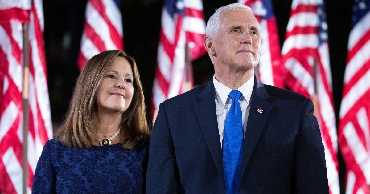 Vice President Mike Pence, right, and his wife Karen Pence join Trump administration officials on stage after President Donald Trump delivered his acceptance speech for the Republican presidential nomination on the South Lawn of the White House on Aug. 27, 2020, in Washington, D.C.