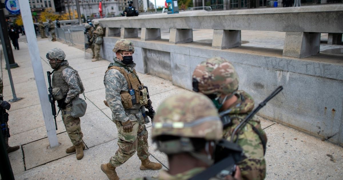National Guard members patrol the area around Philadelphia City Hall on Friday, in Philadelphia.