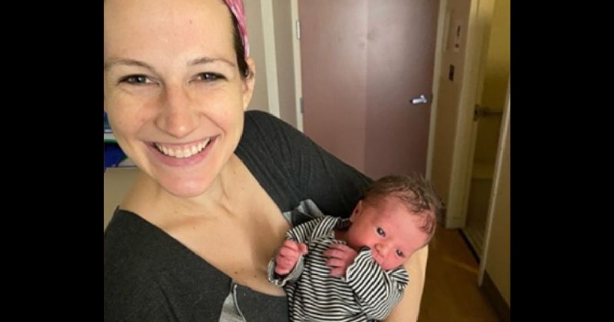 Brianna Hill holds her newborn son, Cassius Phillip Andrew.