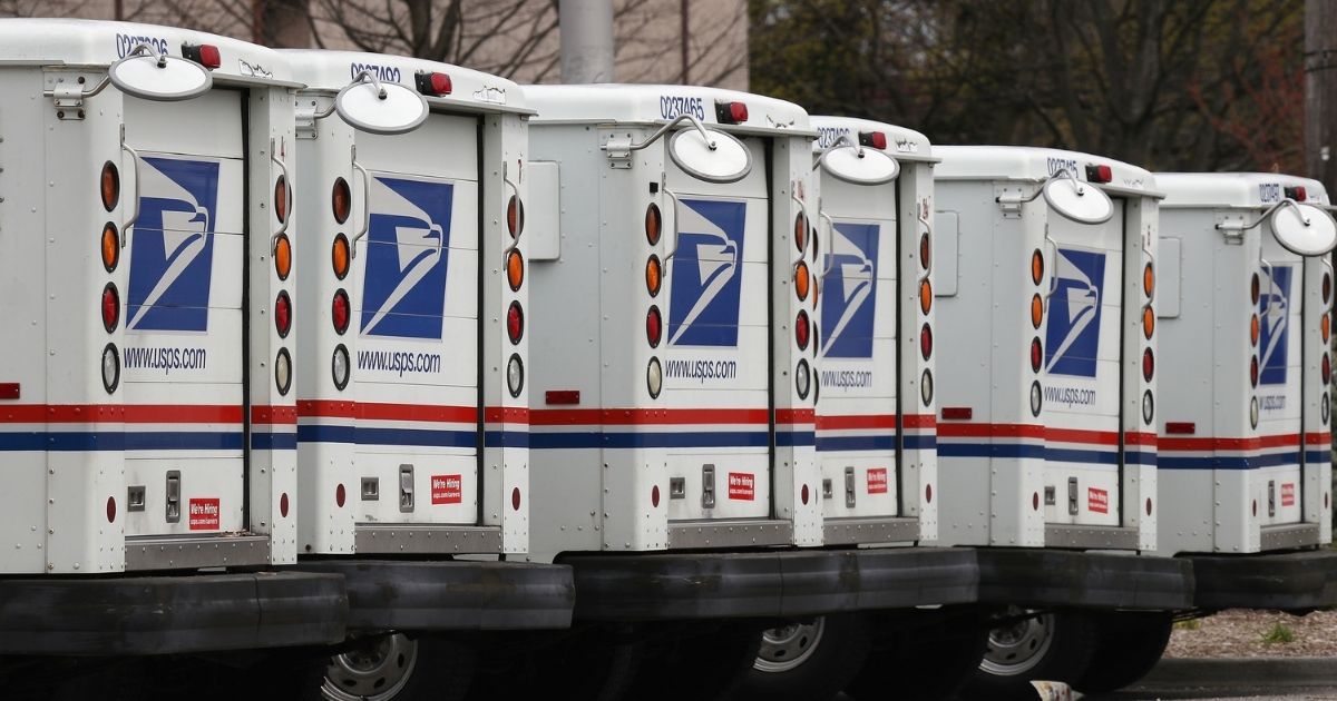 A general view of United States Postal Service trucks is seen above on April 12, 2020, in Farmingdale, New York.