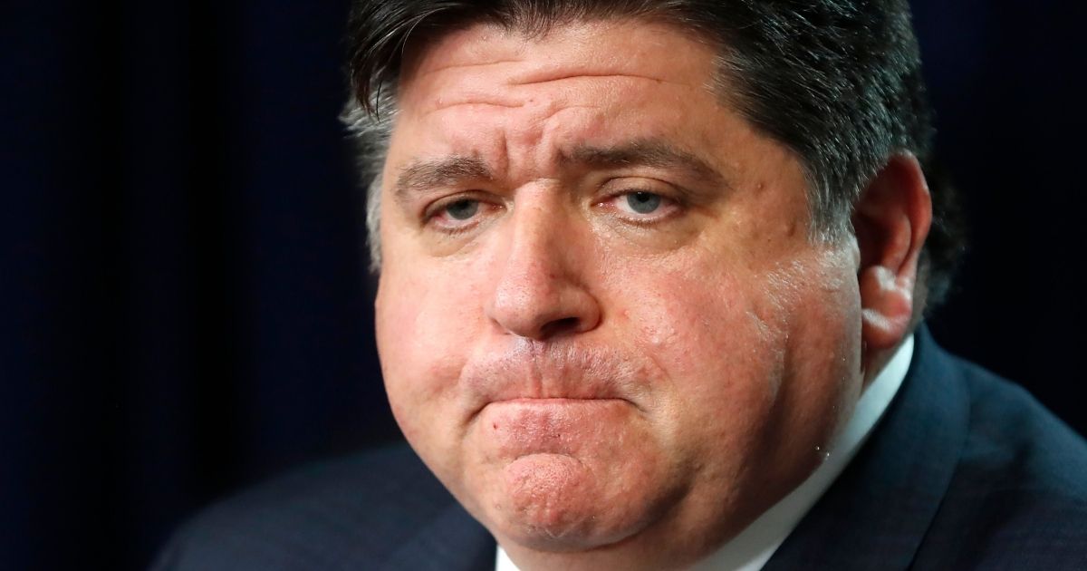 Illinois Gov. J.B. Pritzker listens to a question during a news conference in Chicago on March 19.