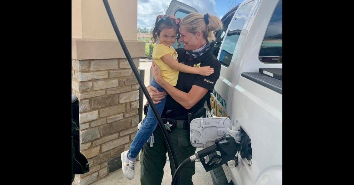 Cpl. Sherry Rego hugs a young girl whose life she saved three years before.