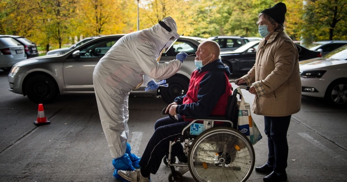 A medic tests a man for the novel coronavirus during nationwide testing in Bratislava, Slovakia, on Saturday.