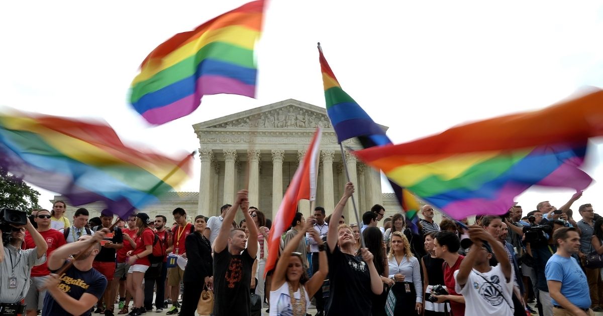 People celebrate outside the U.S. Supreme Court in Washington on June 26, 2015, after its decision approving gay marriage.