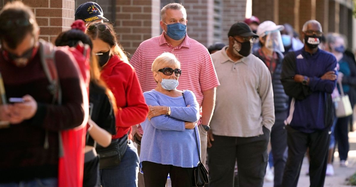 Voters line up for early voting outside Richardson City Hall in Texas on Oct. 13, 2020.