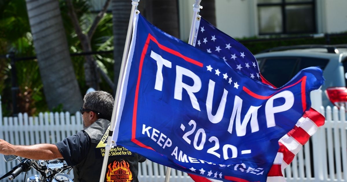 A supporter of President Donald Trump displays his flag on June 14 in Palm Beach, Florida.