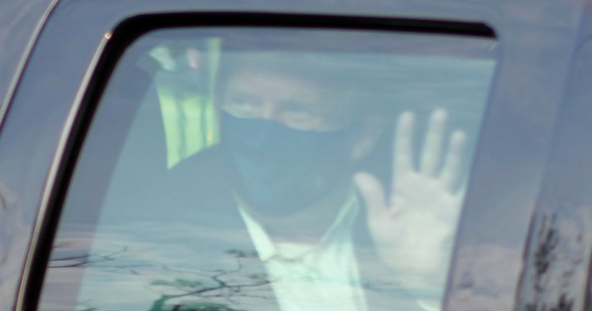 President Donald Trump waves to supporters gathered outside Walter Reed National Military Medical Center in Bethesda, Maryland, on Oct. 4, 2020.