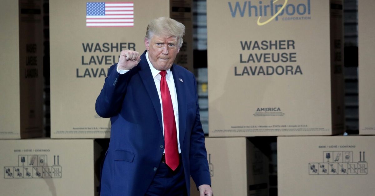 President Donald Trump gestures as he walks off the stage after speaking to workers at a Whirlpool manufacturing facility in Clyde, Ohio, on Aug. 6.