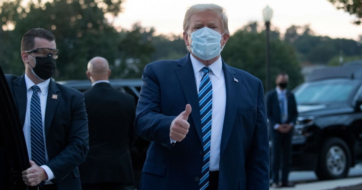 President Donald Trump gives a thumbs-up as he leaves Walter Reed National Military Medical Center in Bethesda, Maryland, and heads toward Marine One on Oct. 5, 2020.