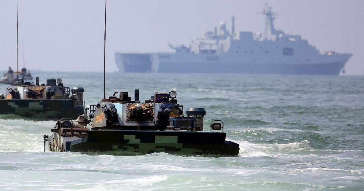 Amphibious armored vehicles attached to a brigade of the PLA Navy Marine Corps make their way to the beach-head during a maritime amphibious assault training in the west of south China's Guangdong Province on August 17, 2019.